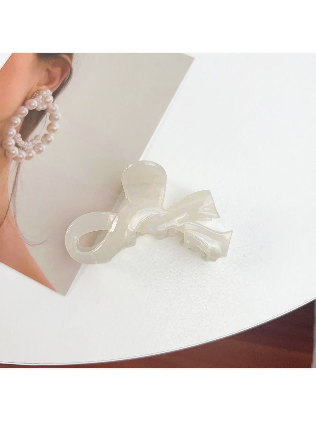 Beau bow shaped hair claw clip resting on a marble countertop