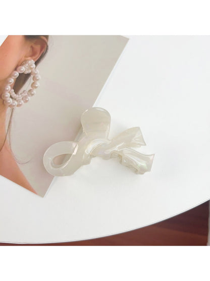 Beau bow shaped hair claw clip resting on a marble countertop