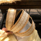 Close-up of woven lace detail on soft straw headband showing texture and pattern