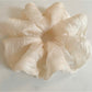 Thin solid color scrunchie wrapped around a ponytail on a model