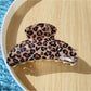 Black glitter and leopard claw clip positioned to show curved shape