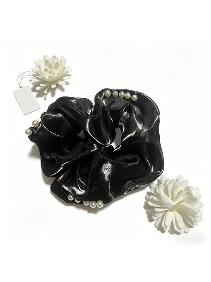 Model wearing Gifty bead embellished tulle scrunchie in hair with casual outfit