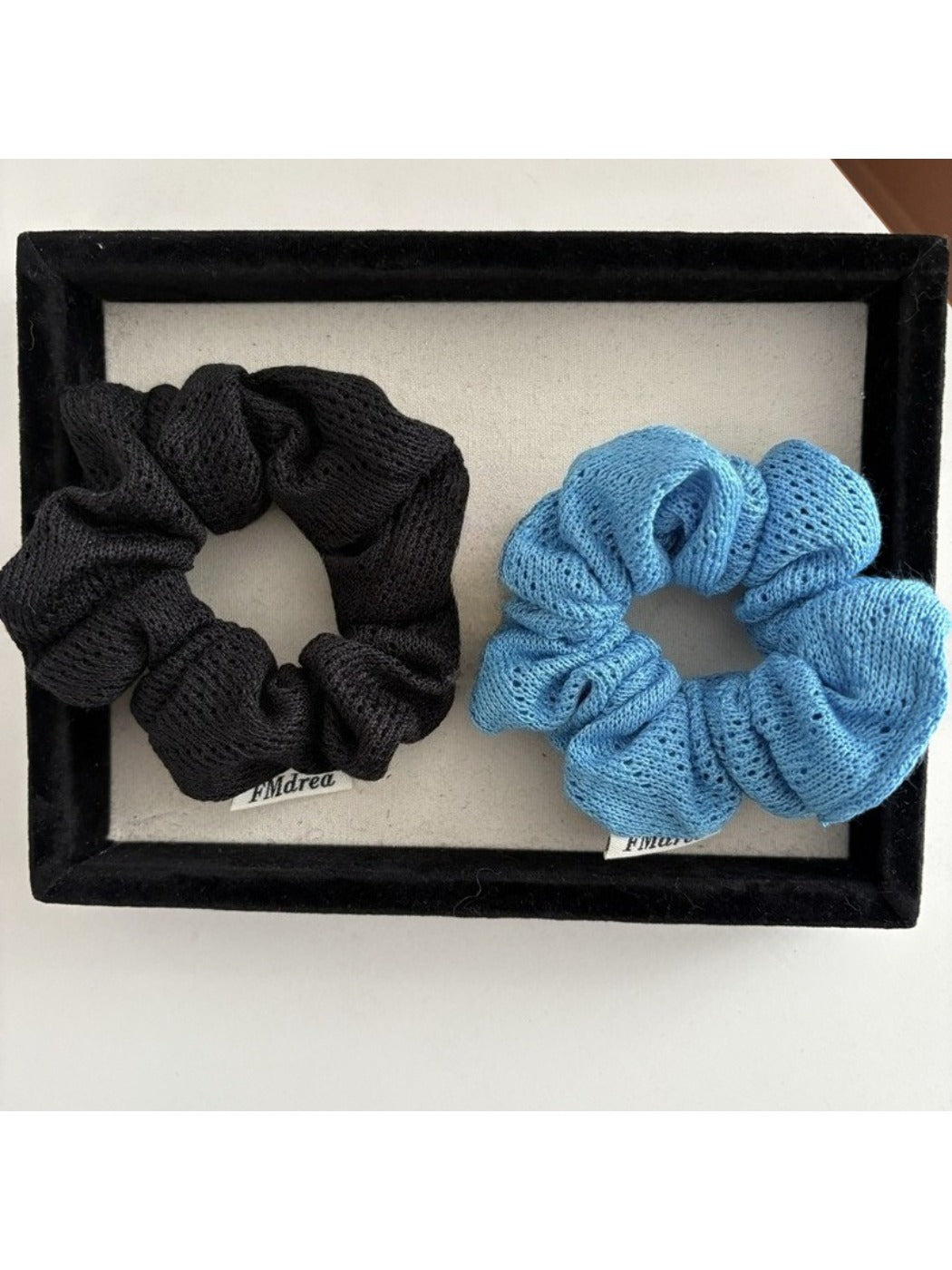 Gifty Lazy Style scrunchie worn on a wrist, highlighting its soft texture and design