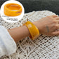 Lovra wide bangle bracelet with irregular contours styled with casual outfit