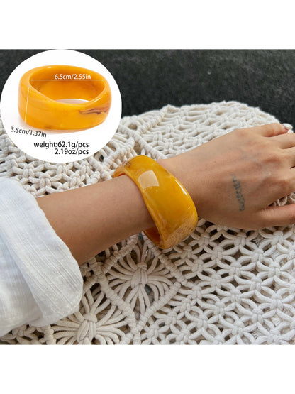 Lovra wide bangle bracelet with irregular contours styled with casual outfit