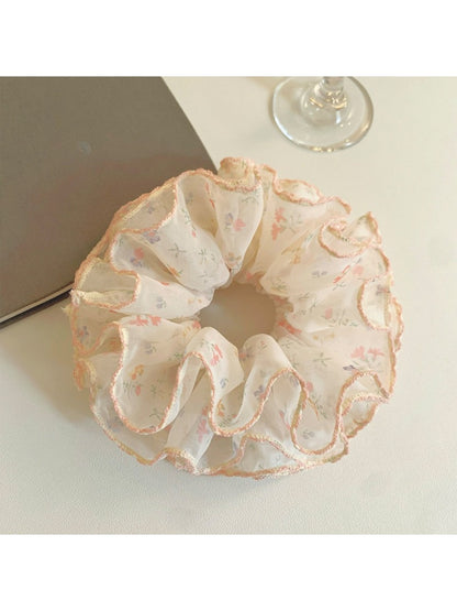 Close-up of Gifty chiffon scrunchie showing delicate floral pattern