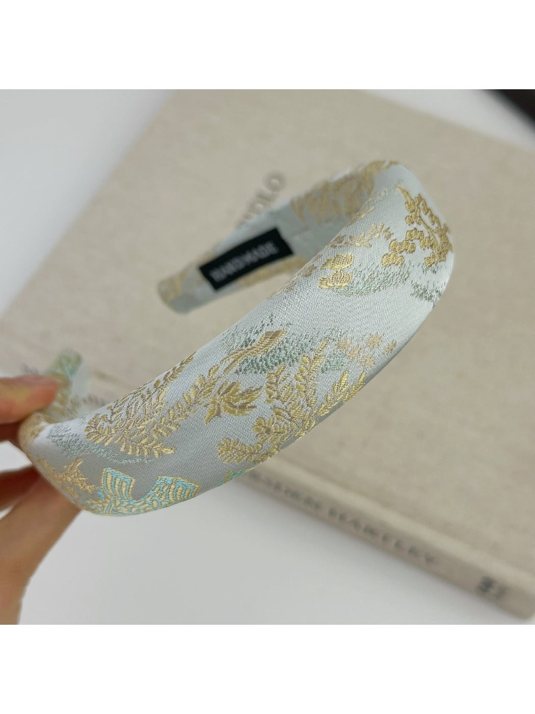 Gifty fabric headband with multicolor flower embroidery laid flat