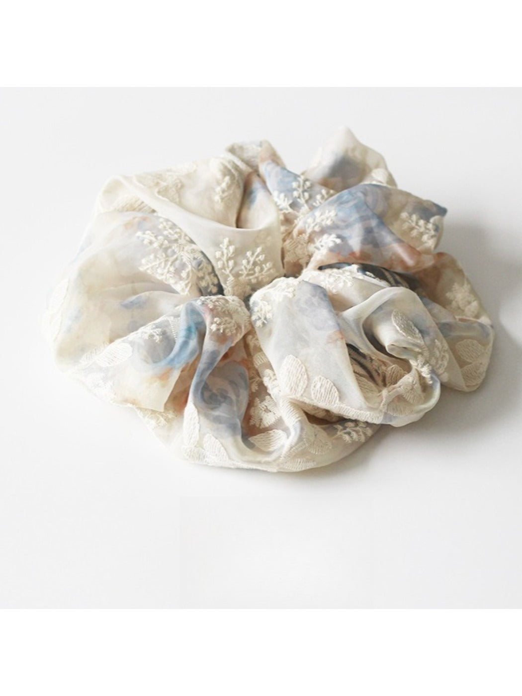 Gifty scrunchie styled in hair with visible ruched and printed details