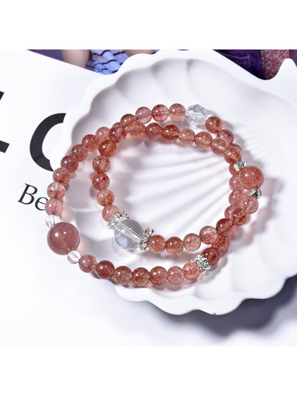 Close-up of Lovra pink crystal beaded bracelet with faceted beads on a white background