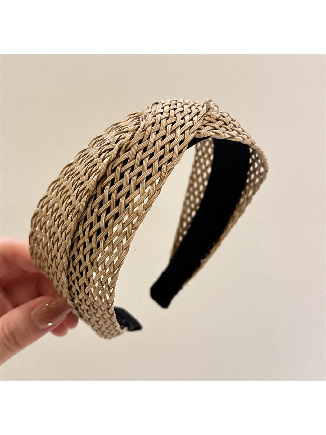 Gifty chic woven cross headband displayed flat with natural lighting