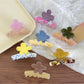 Beau flower shaped claw clip in pastel color block design on white background