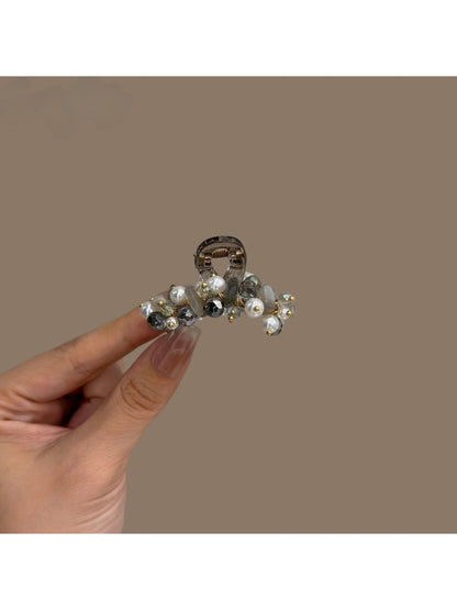 Close-up of Beau hair clip showing detailed bright flower patterns and glossy finish