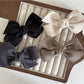 Close-up of Beau satin bow hair clip highlighting smooth fabric texture