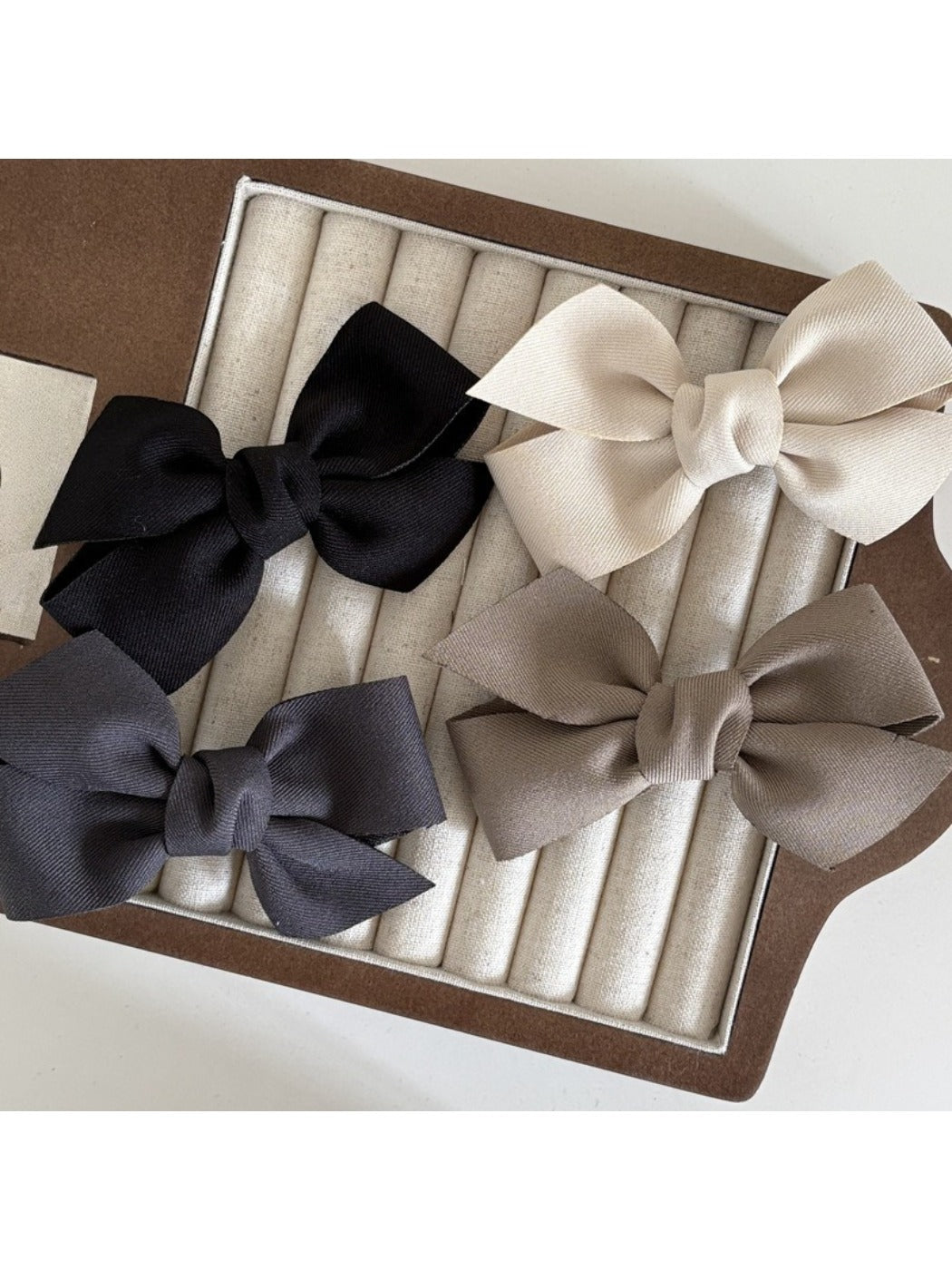 Close-up of Beau satin bow hair clip highlighting smooth fabric texture