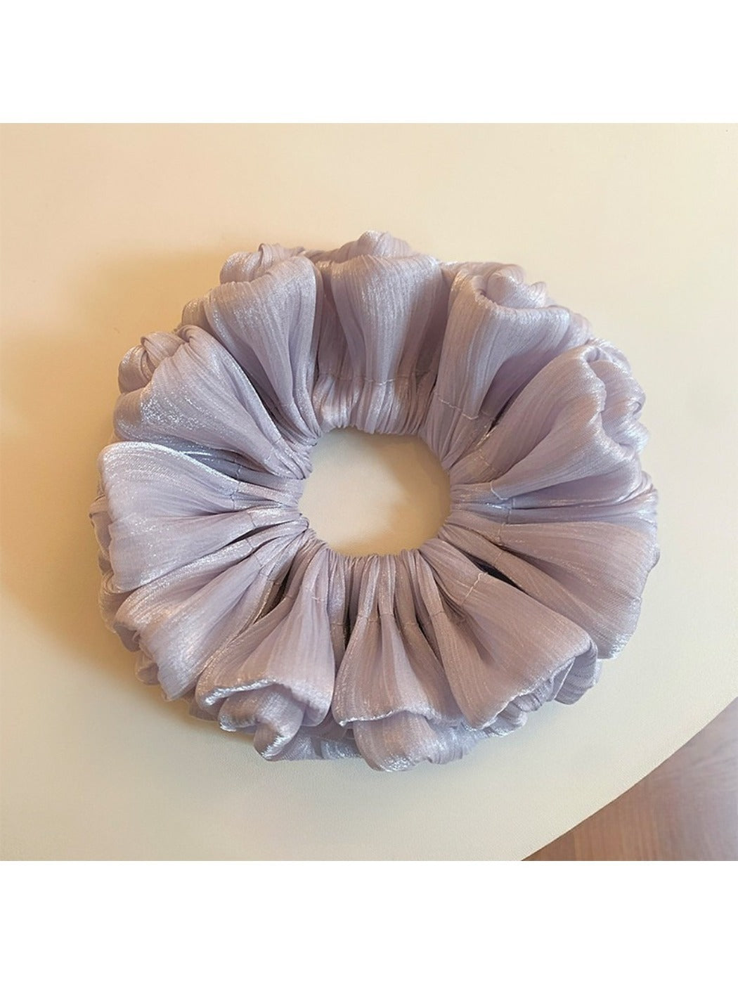 Fashion shot of a purple reflective tulle scrunchie worn in hair with natural light