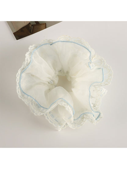 Gifty scrunchie displayed on a white surface highlighting fabric layers