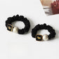 Close-up of Gifty round bead hair tie showing smooth black beads