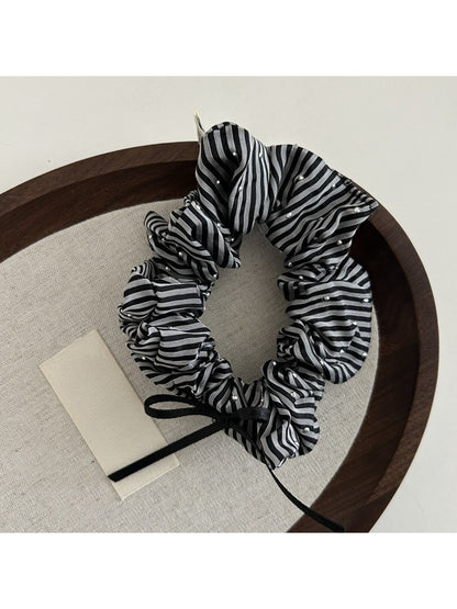 Gifty Sweet Bow Stripe Scrunchie styled in a ponytail with visible bow and stripes