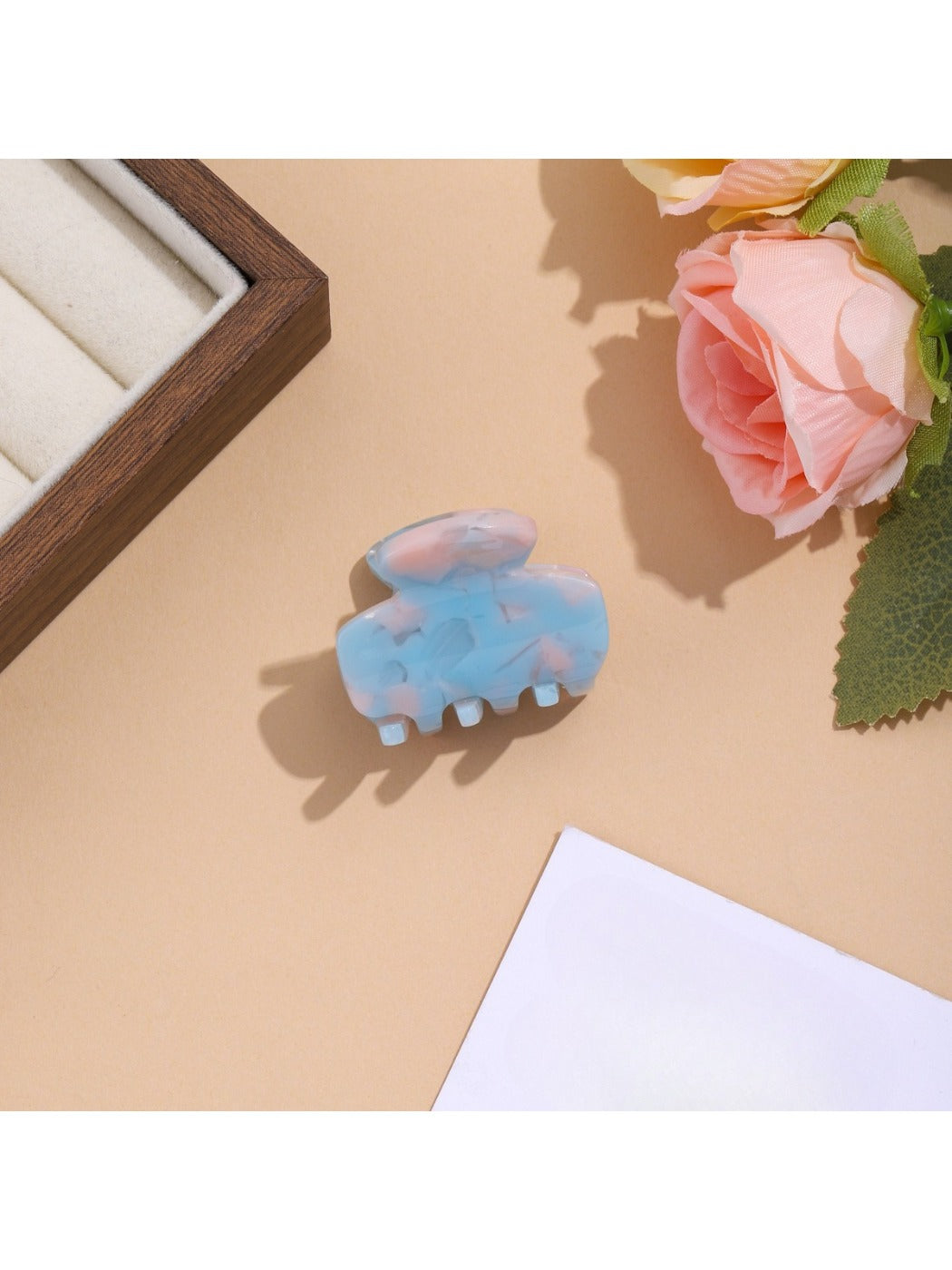 Beau vibrant acetate hair clip displayed on a flat surface with light reflection