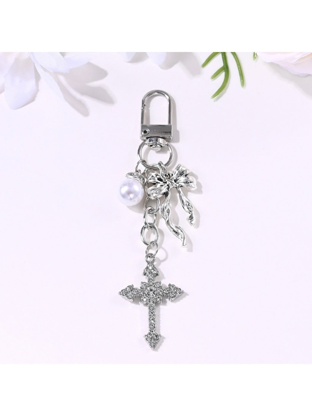 Alloy heart bow keychain shown next to a ruler for size reference