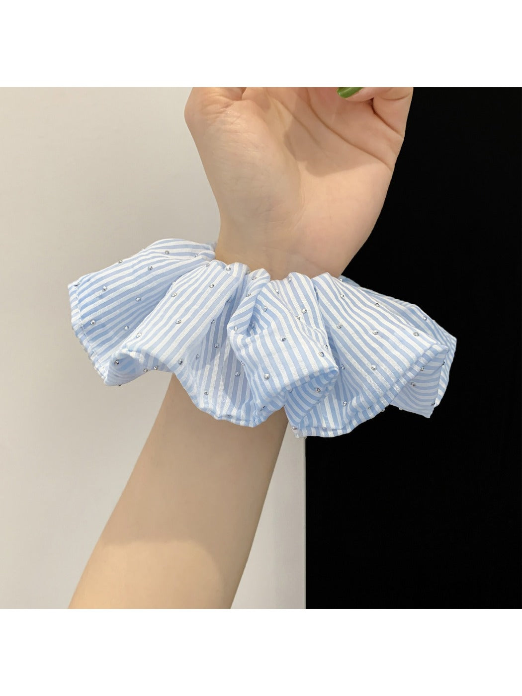 Gifty scrunchie displayed on a wooden surface highlighting its striped pattern
