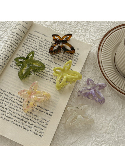 Beau butterfly claw clip open to display inner teeth and clasp