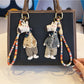 Side view of the giraffe charm keychain showing its textured design