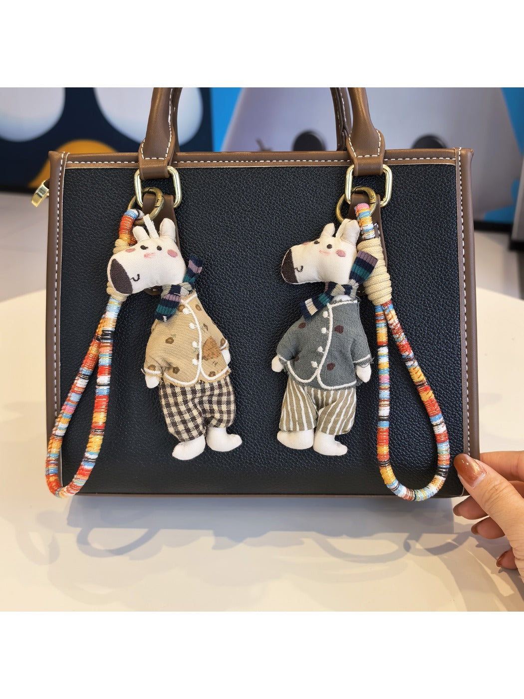 Side view of the giraffe charm keychain showing its textured design