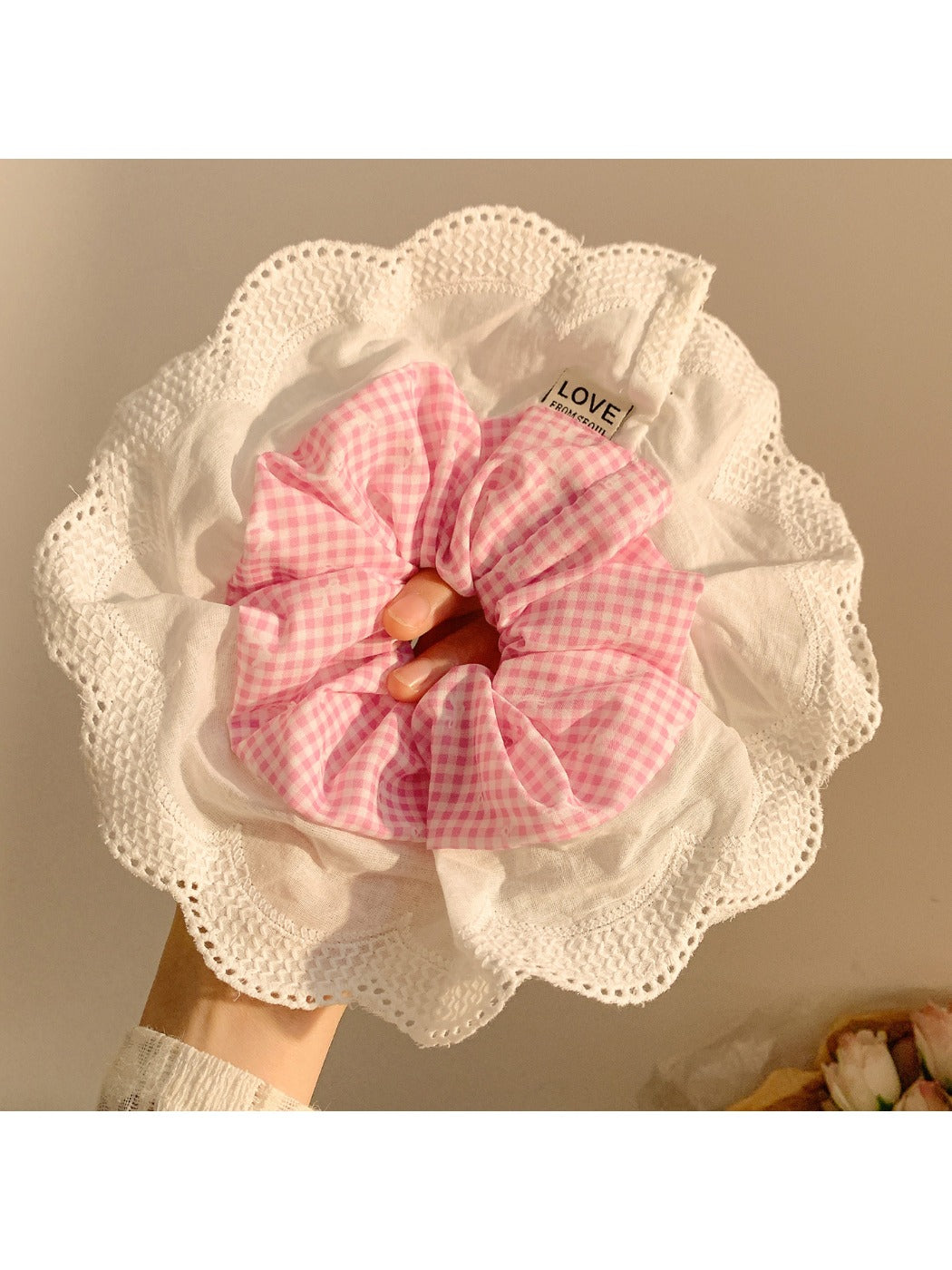 Model wearing large ruffle plaid scrunchie in hair with casual outfit