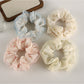 Close-up of Gifty tulle ruffle floral scrunchie with pink and white flowers