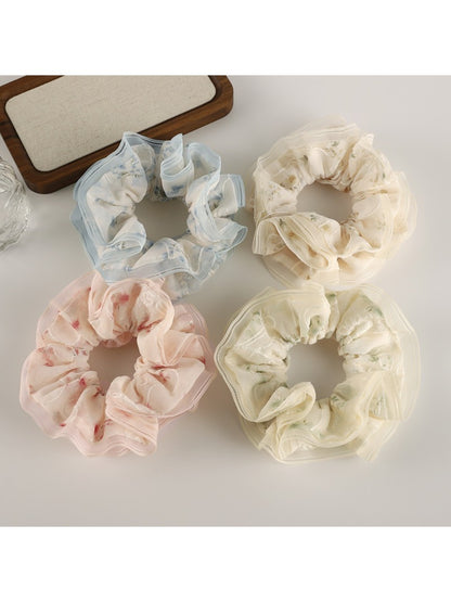 Close-up of Gifty tulle ruffle floral scrunchie with pink and white flowers