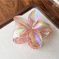 Beau flower shaped claw clip displayed in a flat lay arrangement