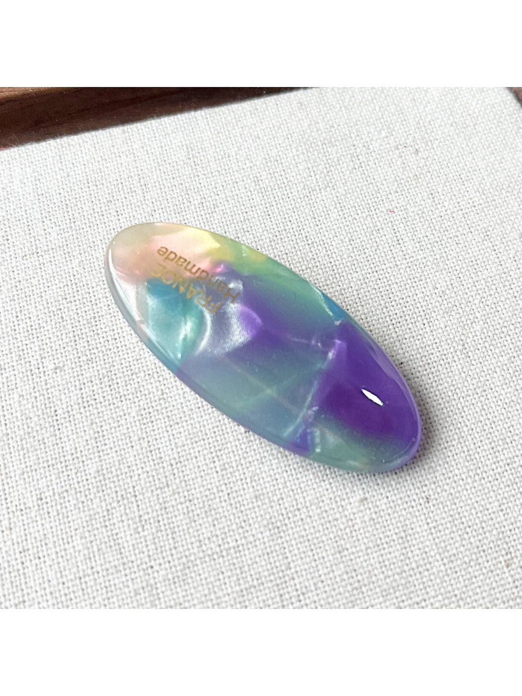Beau Sweet Oval Acetate Hair Clip in natural light on a fabric background