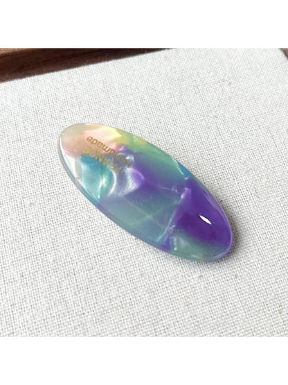 Beau Sweet Oval Acetate Hair Clip in natural light on a fabric background