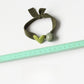 Yellow hair tie with a red heart charm shown in hand