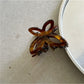 Beau Misty Acetate Butterfly Hair Clip photographed from above on neutral background