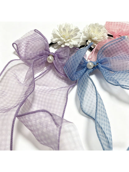 Close-up of red and black plaid tulle bow hair tie showing fabric texture