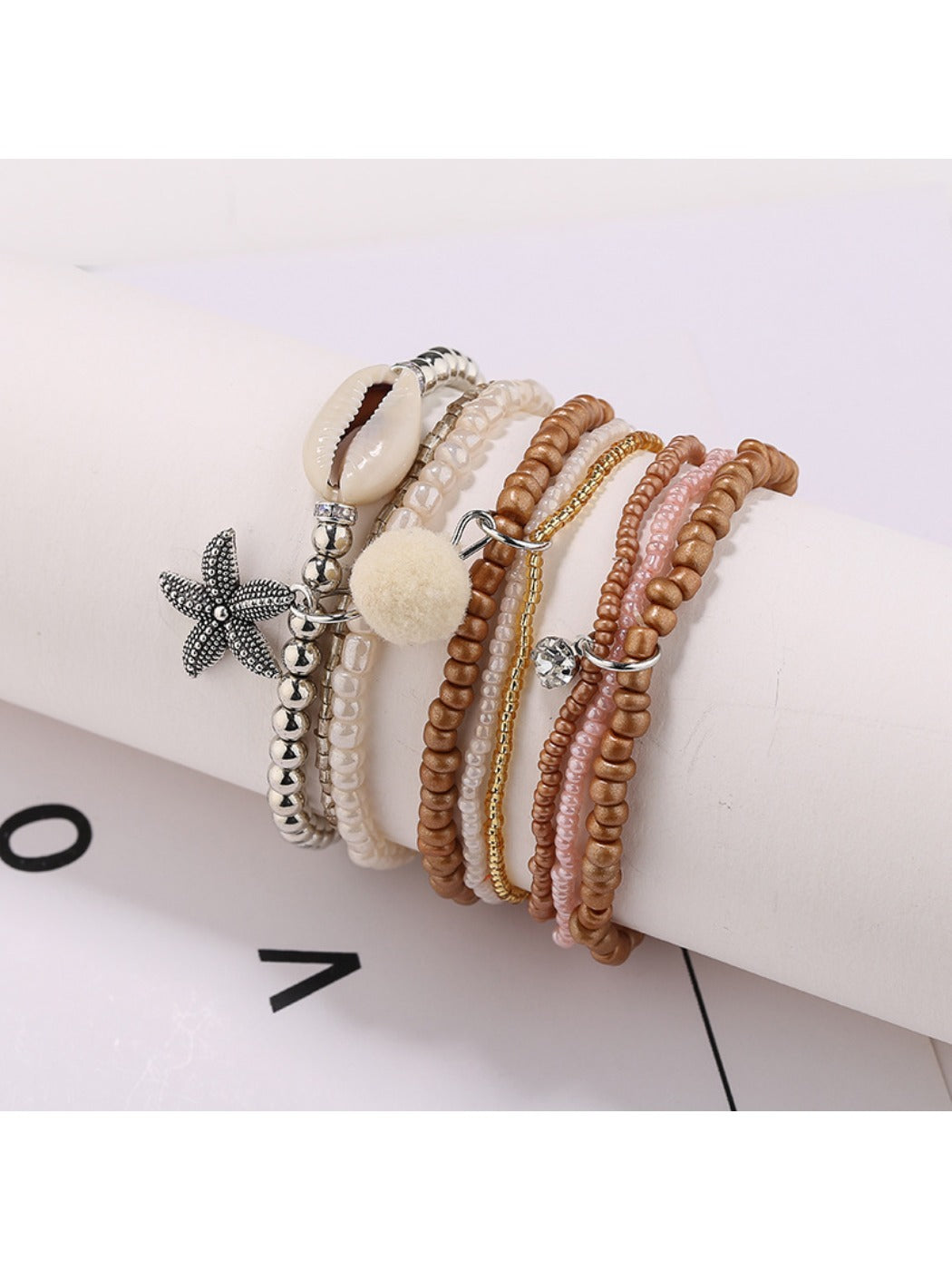 Lovra bracelet with small round gold and silver beads arranged in multiple rows