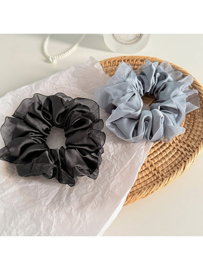 Gifty scrunchie displayed on a wooden surface highlighting texture
