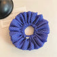 Close-up of blue polka dot scrunchie fabric texture and pattern