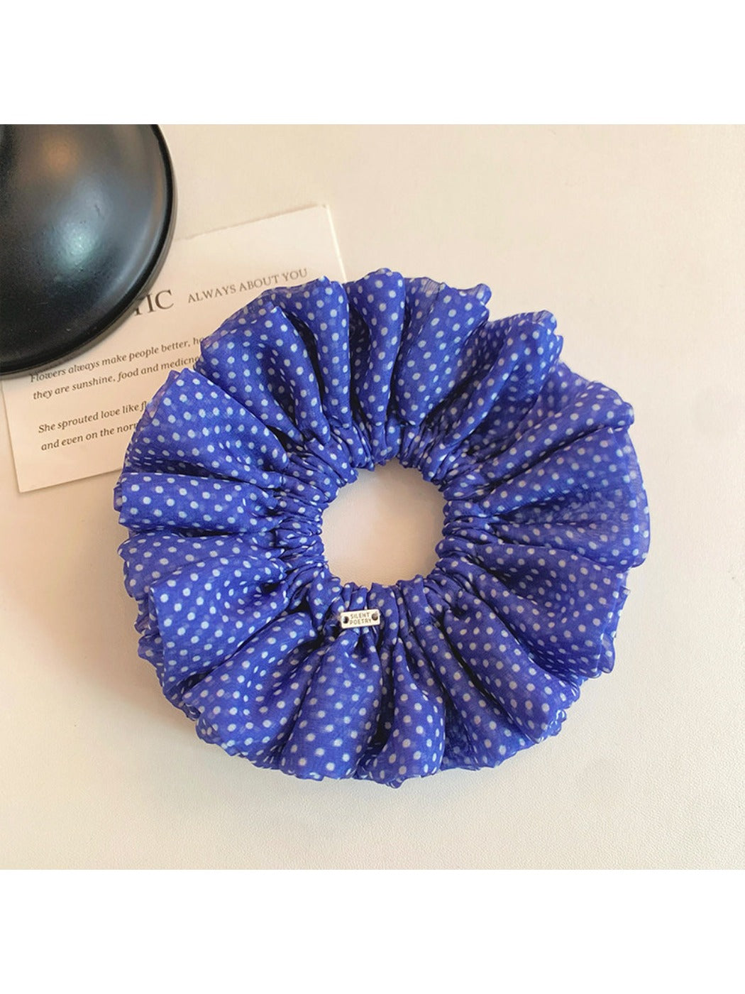 Close-up of blue polka dot scrunchie fabric texture and pattern