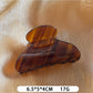 Beau Sweet Chic acetate claw clip with light reflecting off its smooth surface