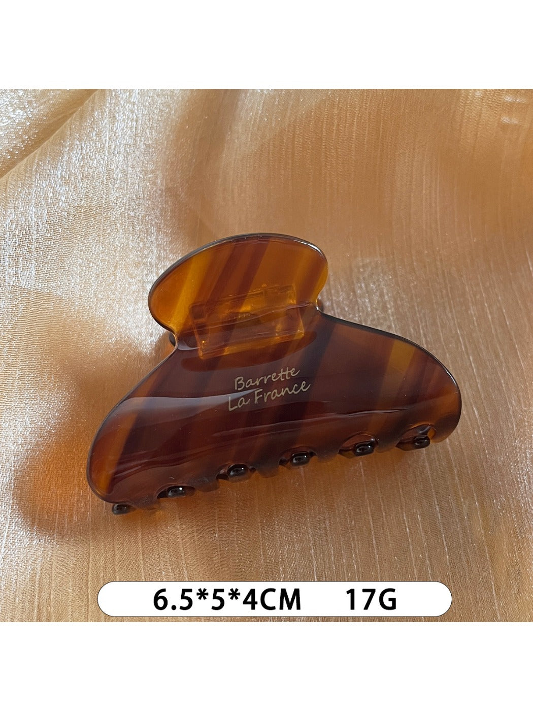 Beau Sweet Chic acetate claw clip with light reflecting off its smooth surface