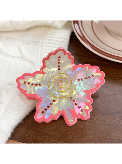 Beau vintage leaf shaped hair claw clip placed on wooden surface with natural light