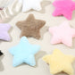 Close-up of plush star shaped hair clip showing soft texture and stitched edges