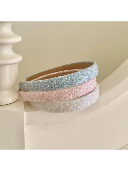 Model wearing Gifty Dreamy Sparkly Sweet Headband with soft pink glitter and bow