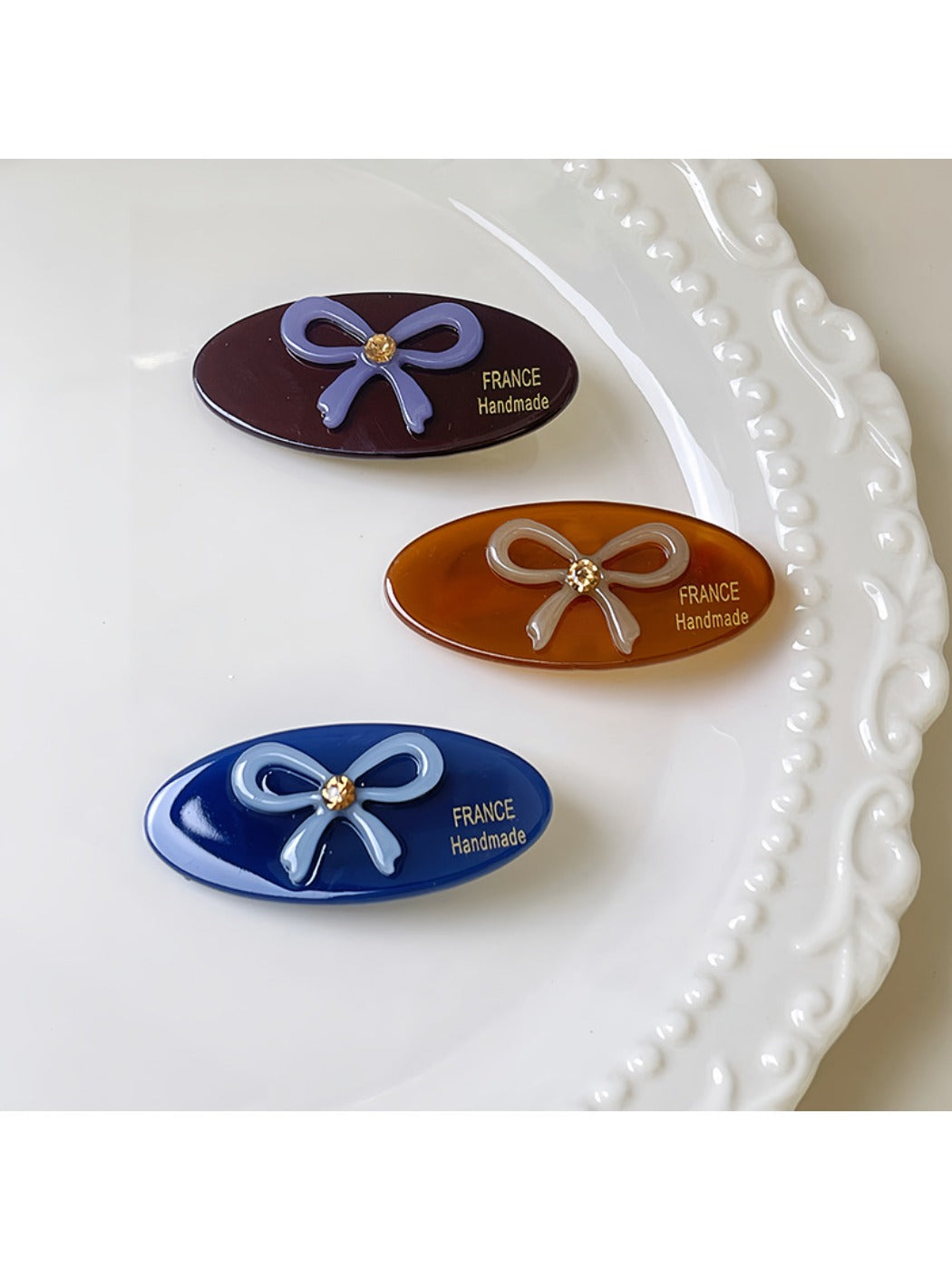 Side view of minimalist oval butterfly hair clip highlighting clip mechanism