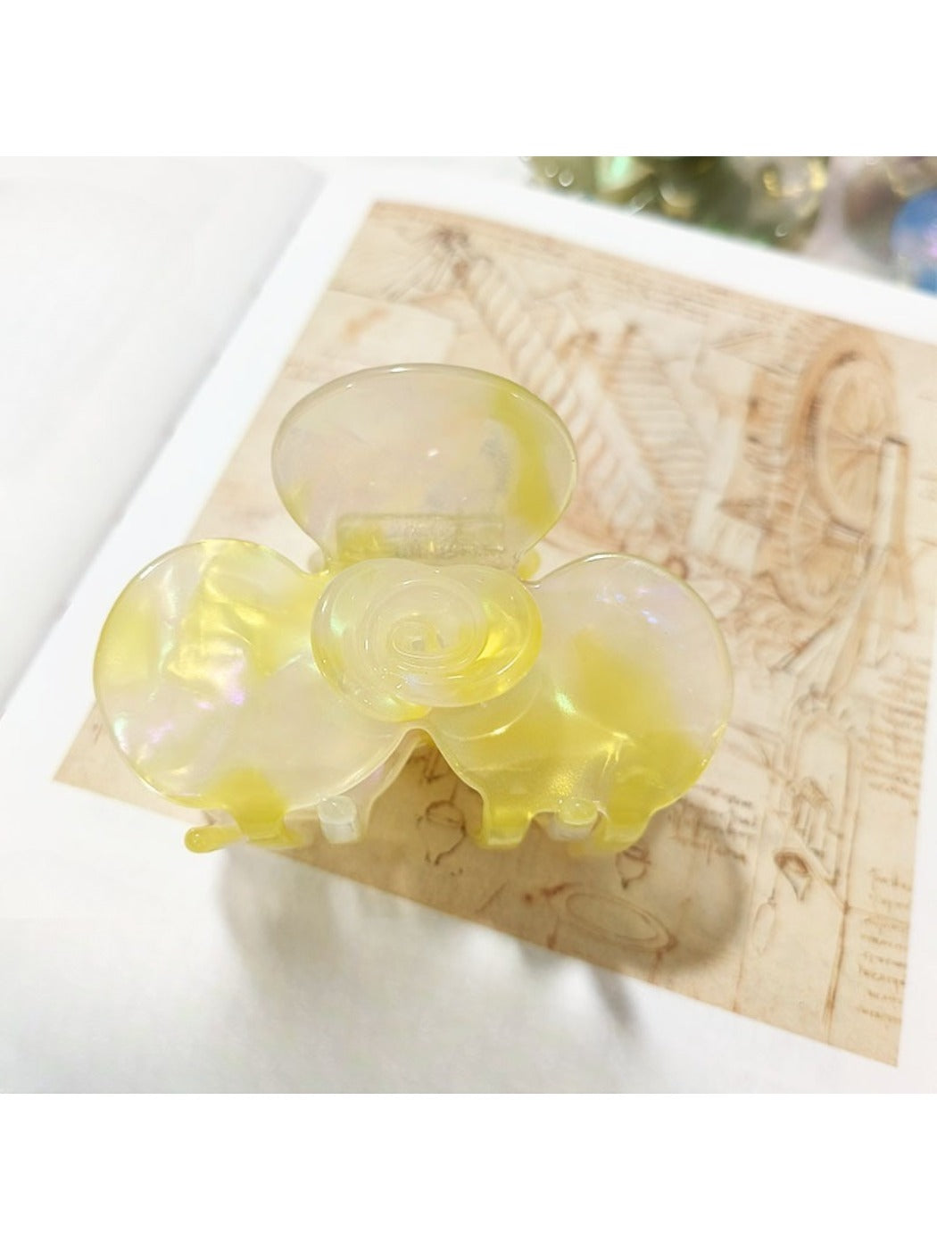 Beau Sweet Acetate Medium Flower Claw Clip with light reflecting off smooth acetate finish