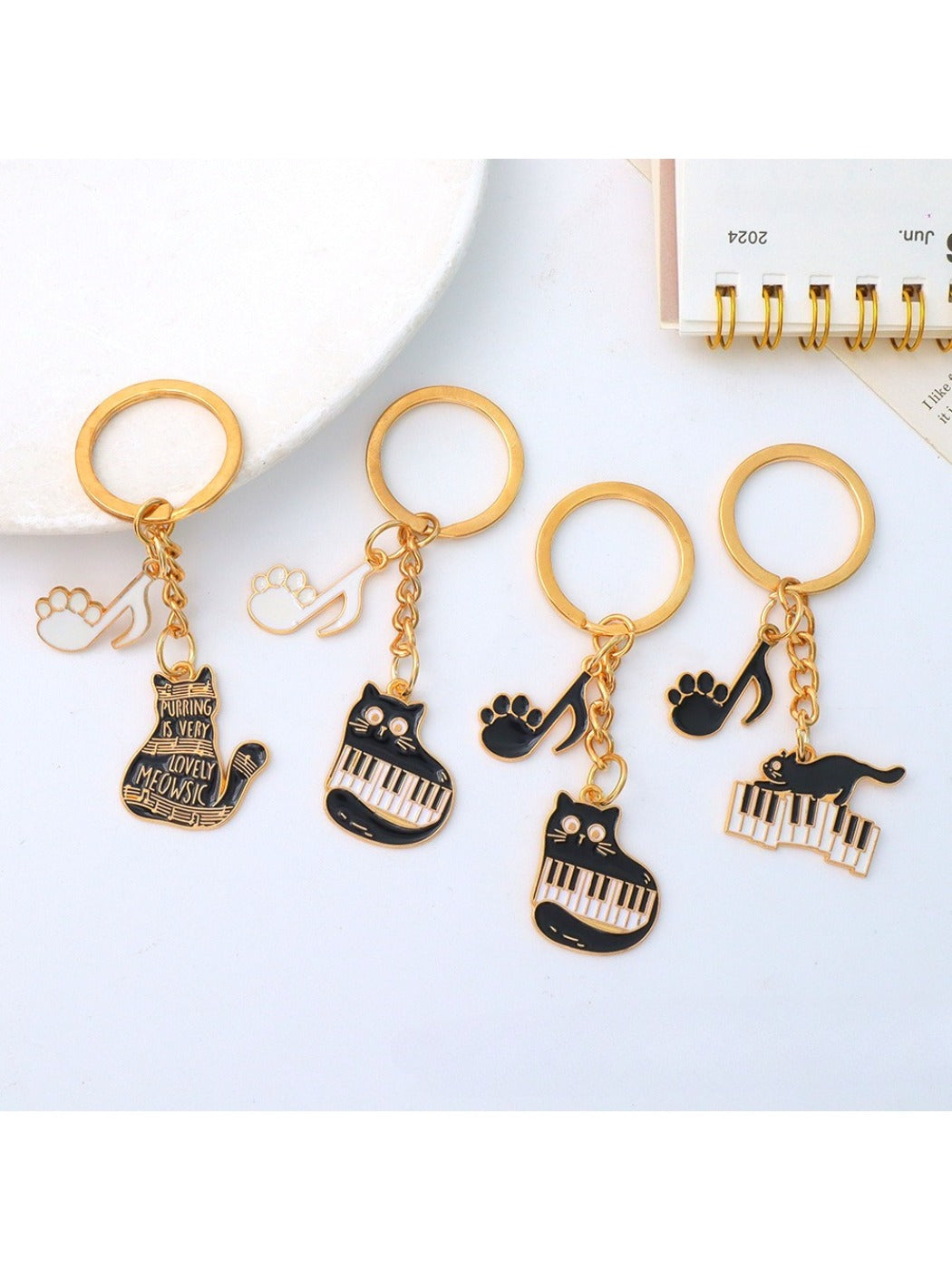 Cartoon cat piano keychain held in hand demonstrating size and portability