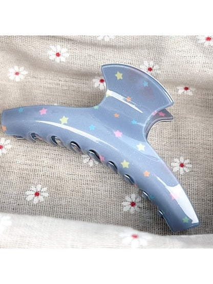 Beau hair claw clip displayed on a wooden surface